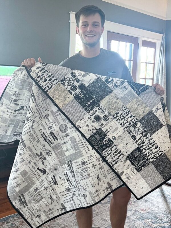 Marshall with the quilt Mom made for him, Brian King